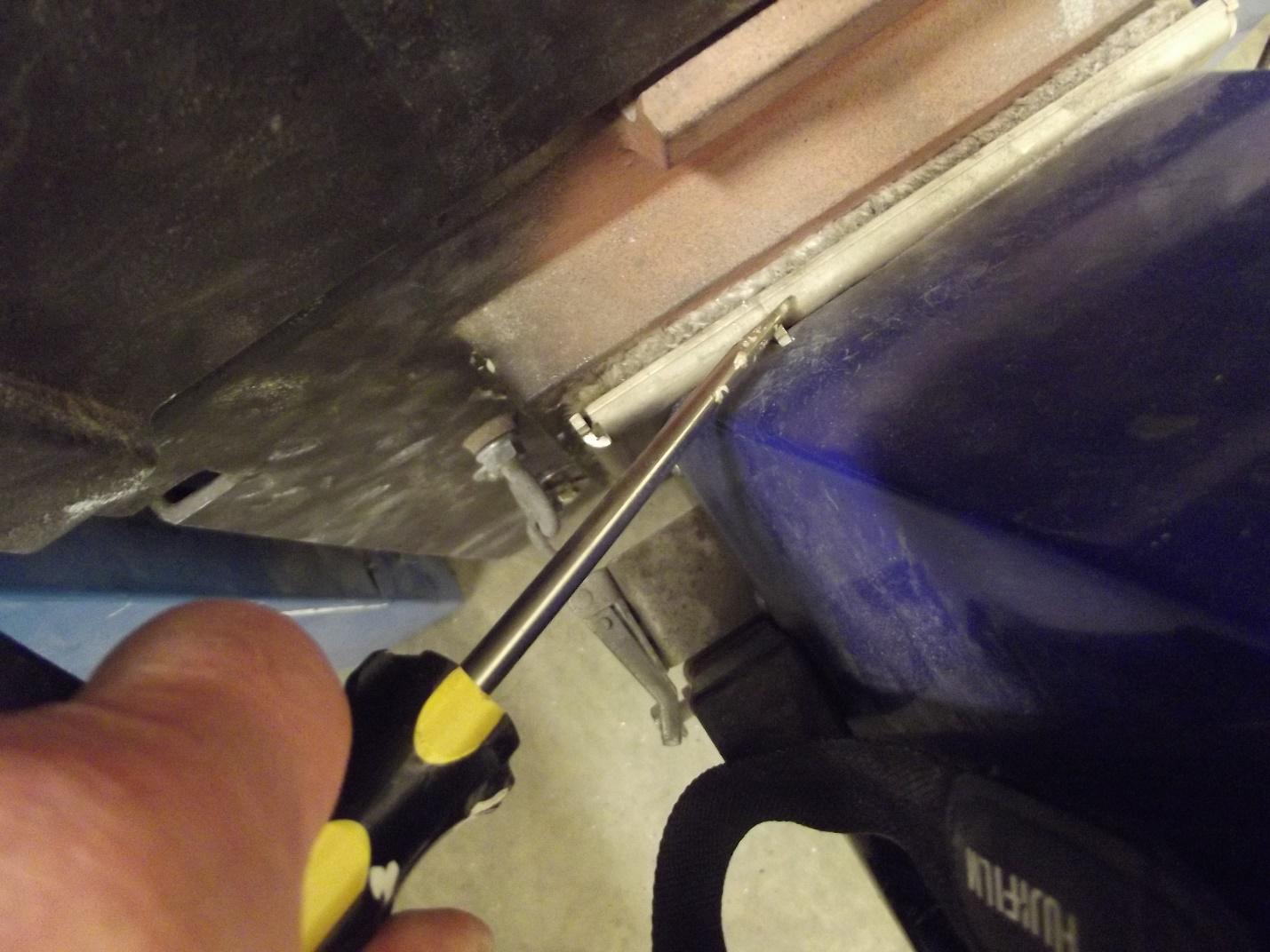 Image of "Safety Switch Plunger" pushed back with a flat-head screwdriver