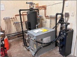 The new ground-source geothermal heat pump at Concord Quaker meetinghouse is much smaller than the pellet boiler system, freeing up space for storage.